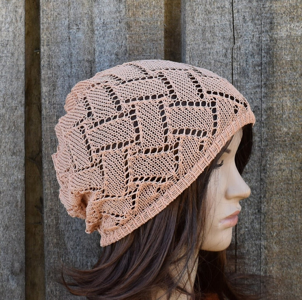 Person wearing a pink knitted beanie against a wooden background