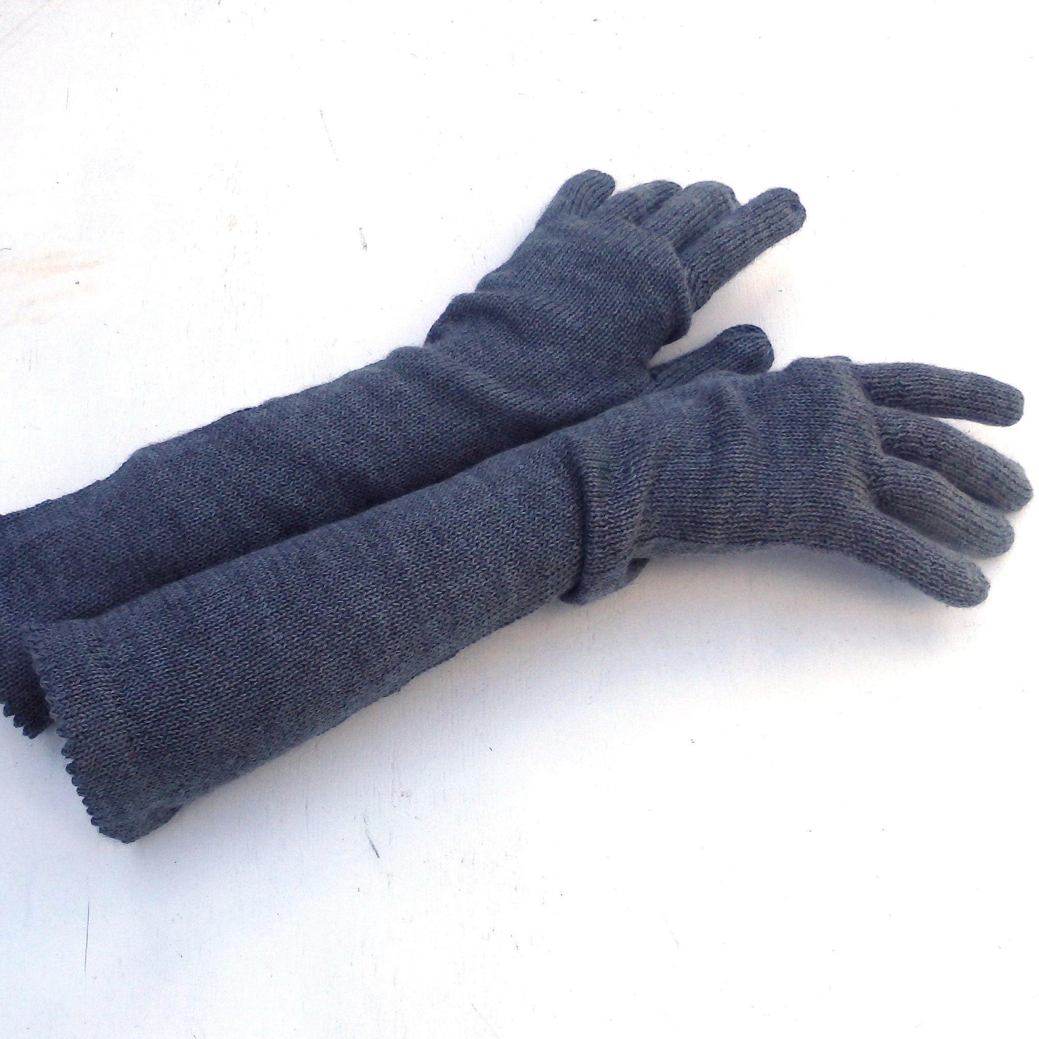 Pair of dark gray gloves on a white background
