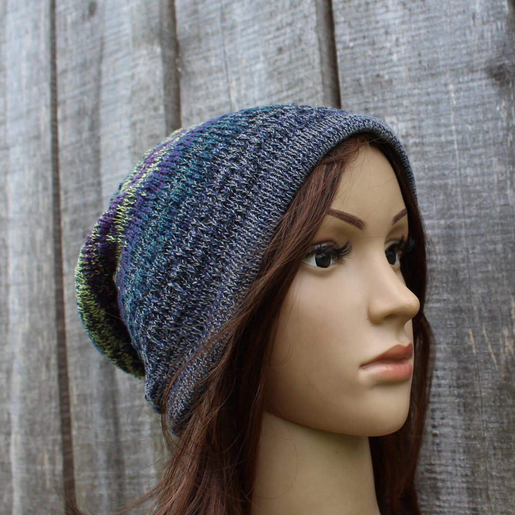 Knitted beanie on a mannequin head against a wooden background