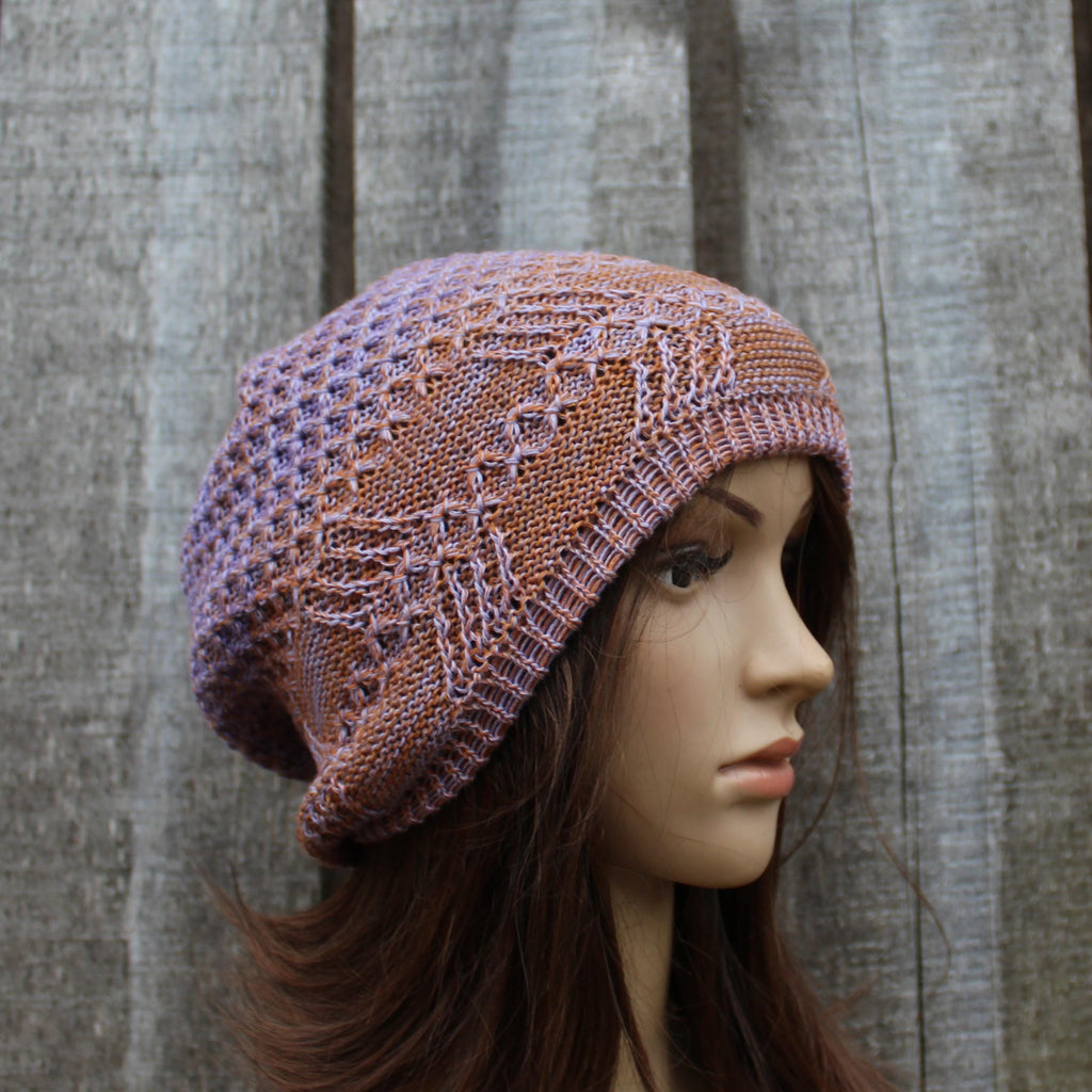 Knitted hat on a mannequin head against a wooden background