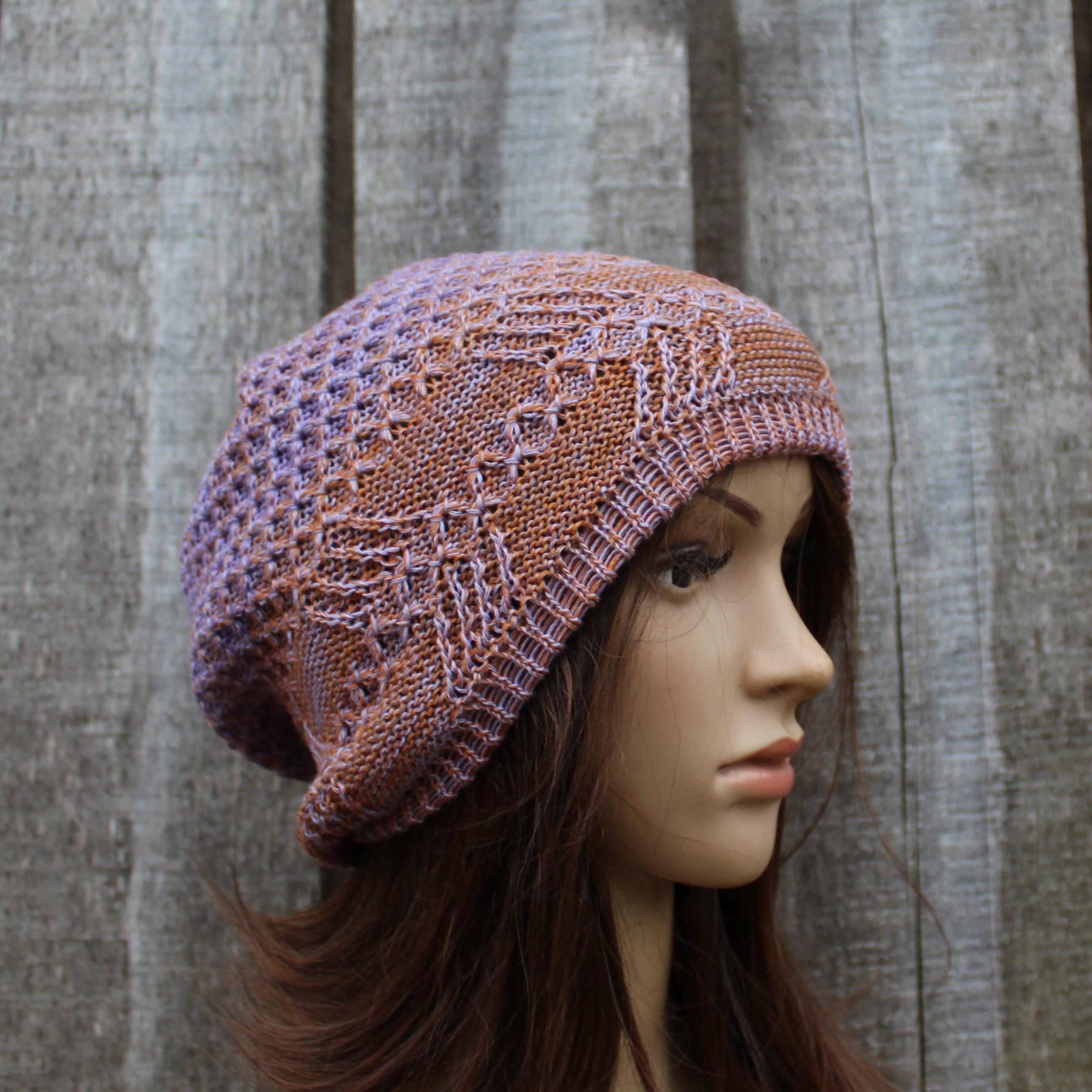Knitted hat on a mannequin head against a wooden background