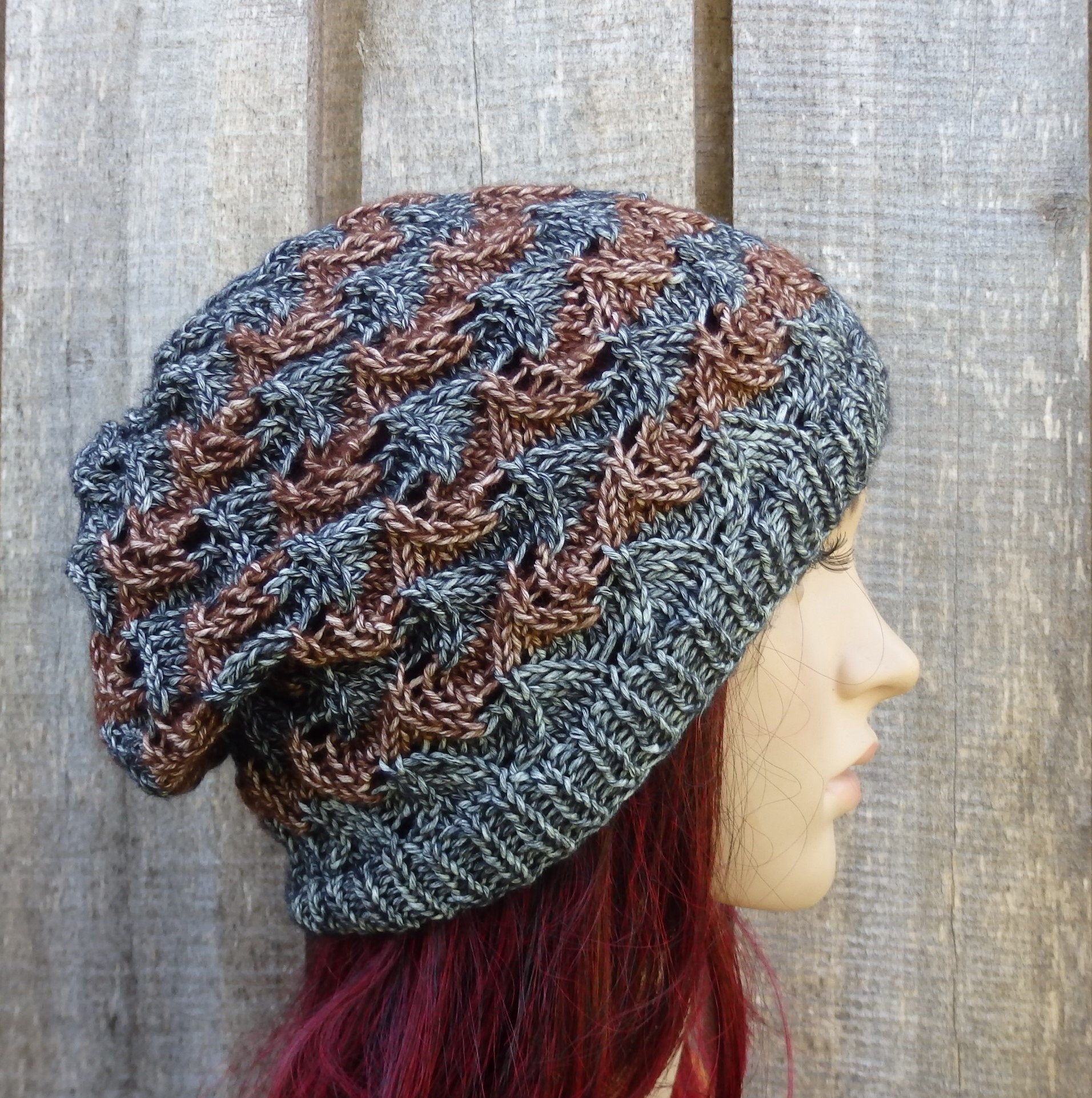 Knitted hat with a textured pattern worn by a mannequin against a wooden background