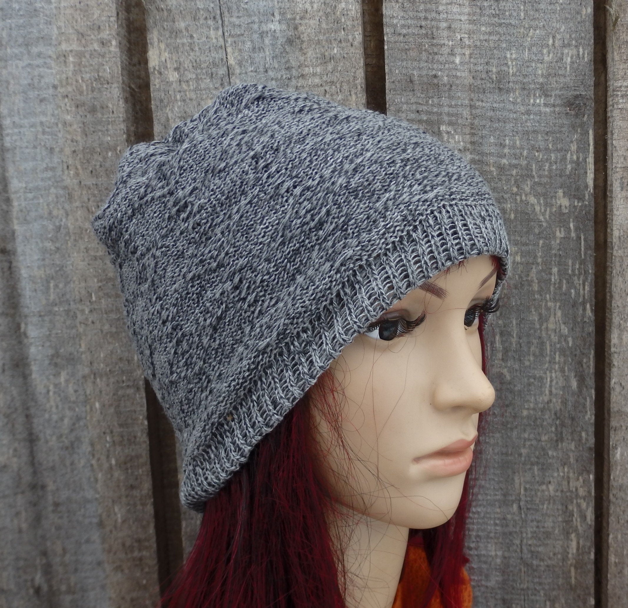 Gray knit beanie on a mannequin head against a wooden background